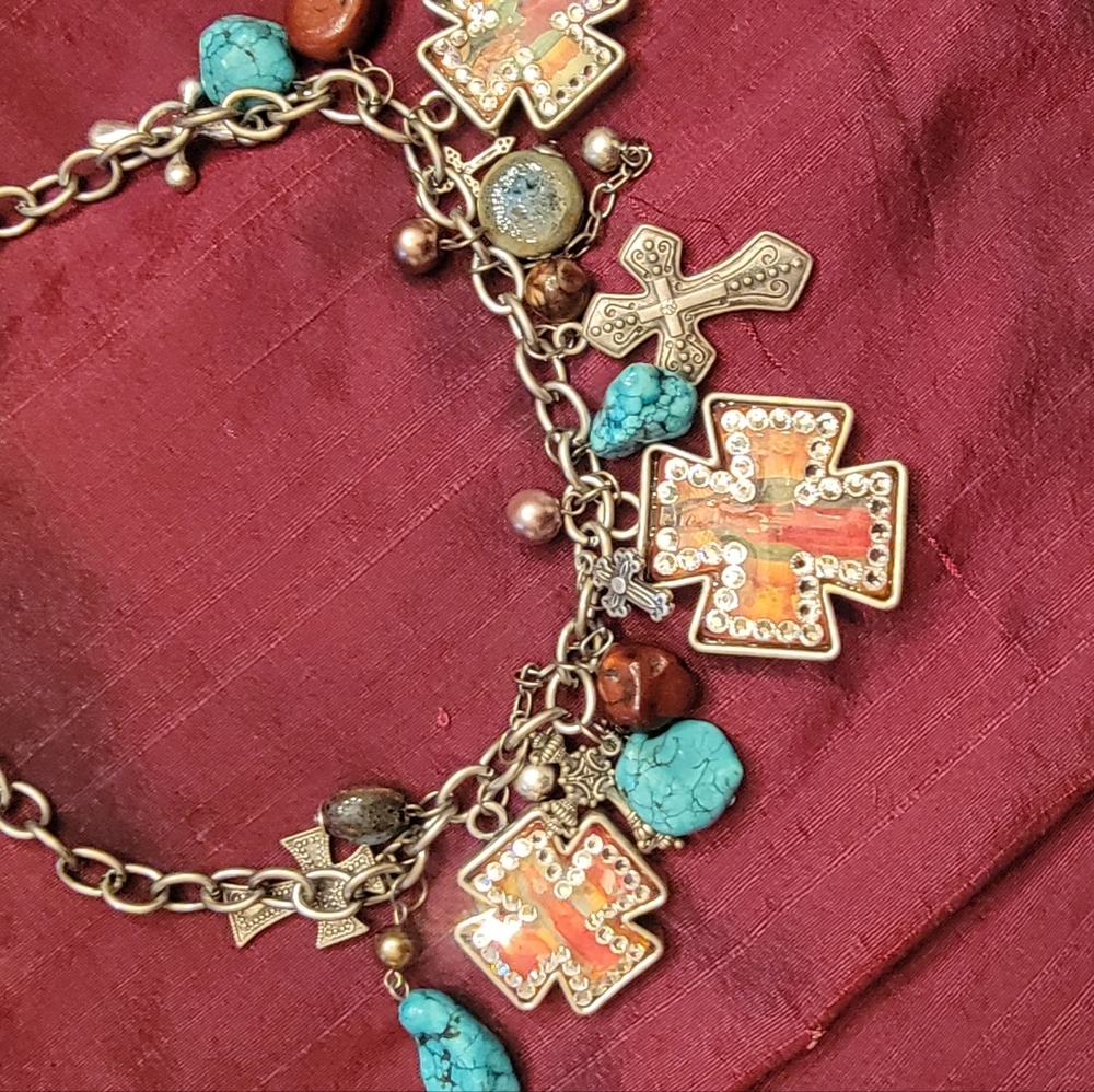 Necklace with many unique hanging items to make a statement when wearing..